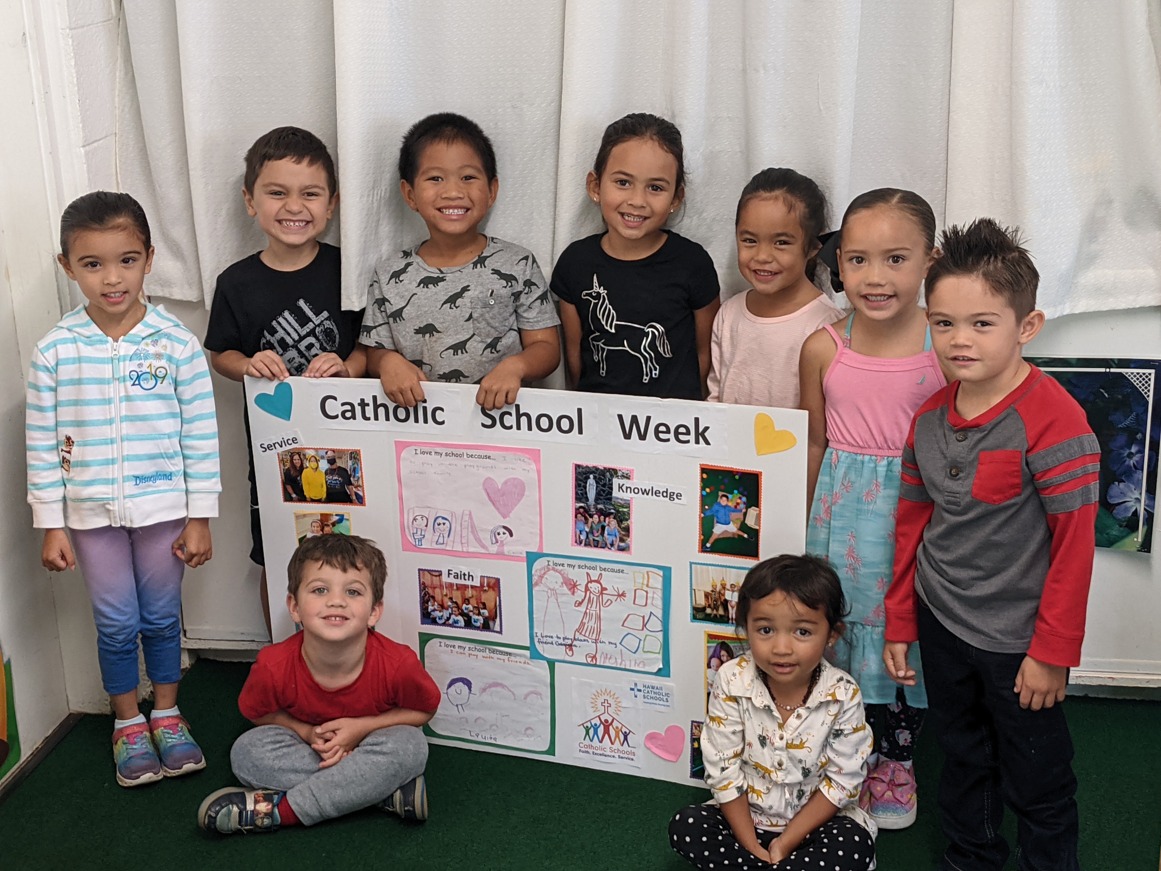 Children showing poster for Catcholic Schools Week